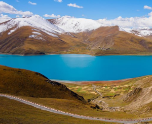 Yamdrok Tso Lake with turquoise blue waters and snow-capped mountains in the background, Tibet