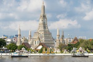 Wat Arun temple with its distinctive spires along the Chao Phraya River in Bangkok, Thailand
