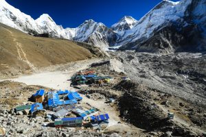 Gorak Shep village with teahouses near Everest Base Camp, surrounded by rocky terrain, glaciers, and snow-covered Himalayan peaks.
