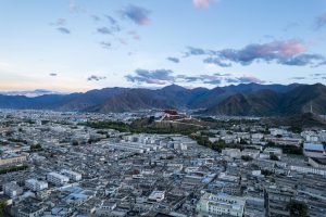Lhasa city skyline at dawn with Himalayan mountains in the background, Tibet