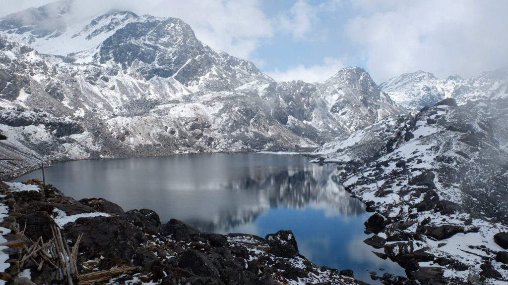 Gosaikunda Lake surrounded by snow-capped Himalayan mountains in Langtang National Park Nepal.