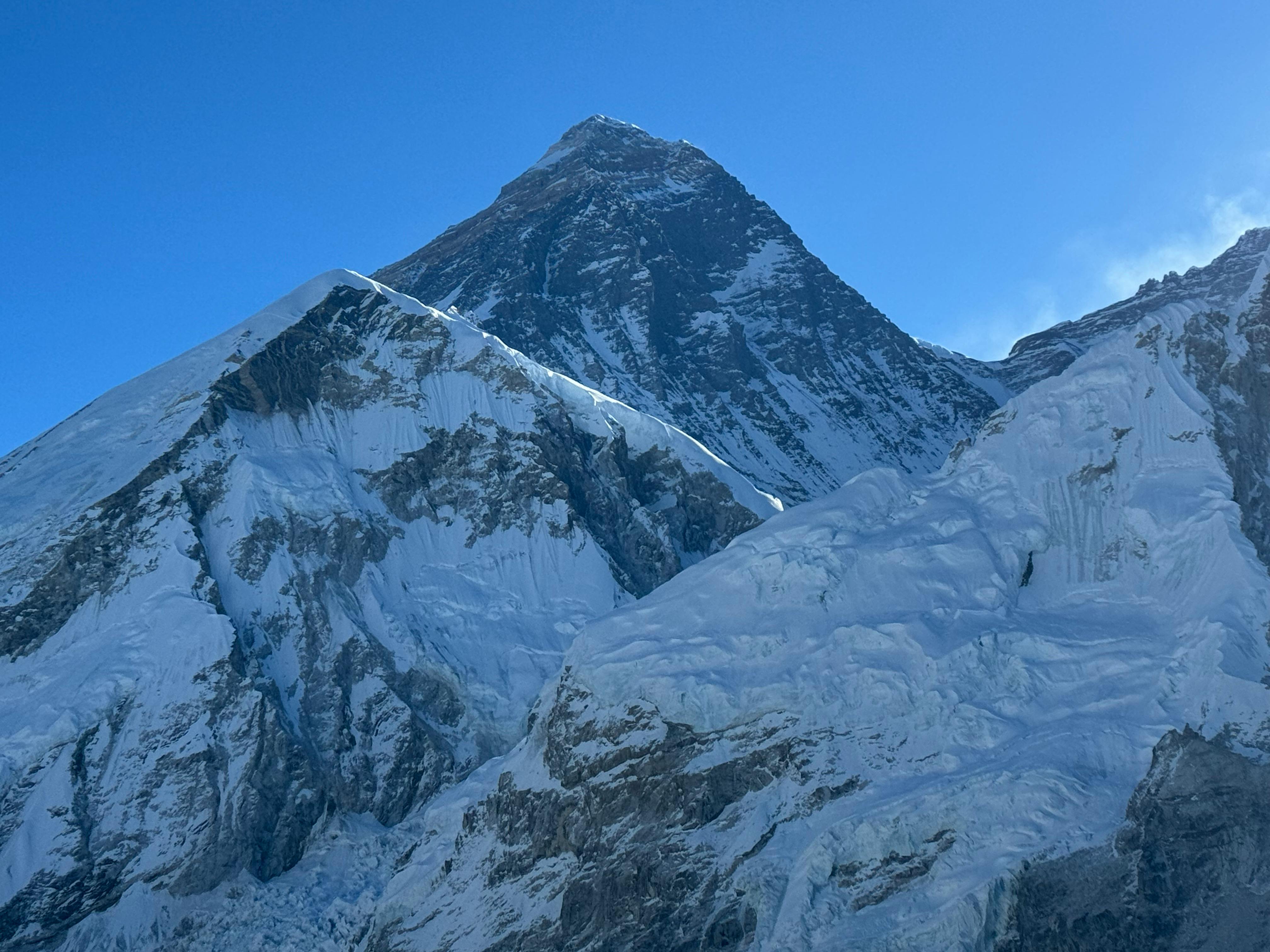 Close-up view of the Mount Everest summit pyramid and surrounding snow-capped peaks in Nepal as seen from Kala Patthar.