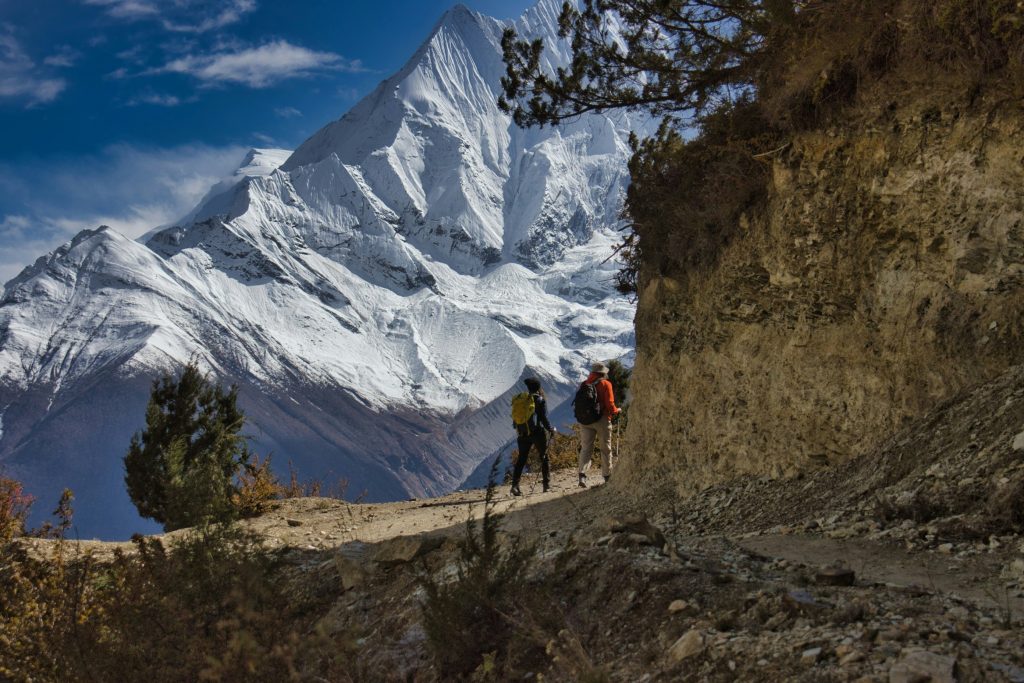 Prayer flags hanging in front of snow-capped Annapurna mountain range in Nepal.