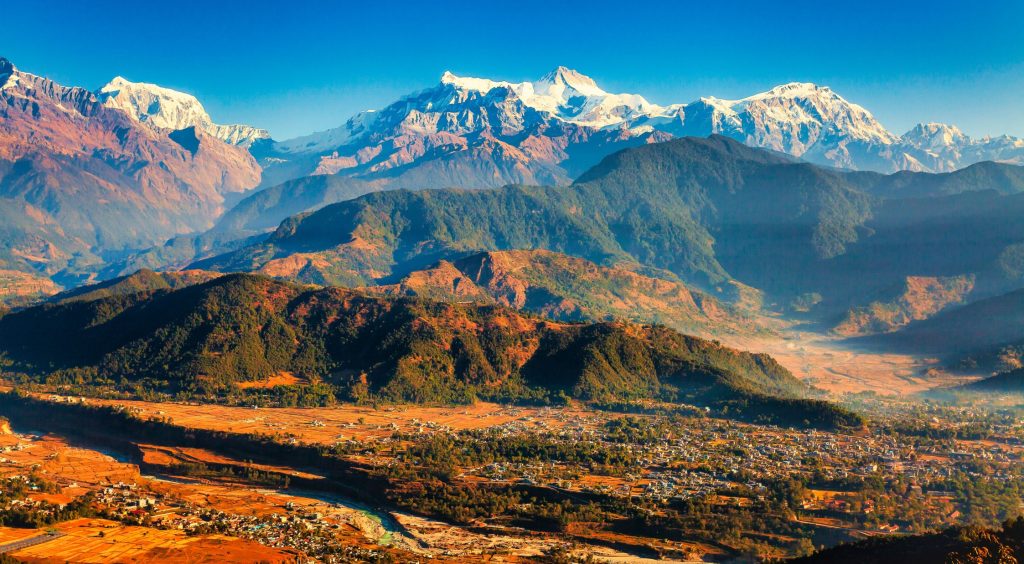  Panoramic view of the snow-capped Annapurna mountain range and hills over Pokhara Valley in Nepal.