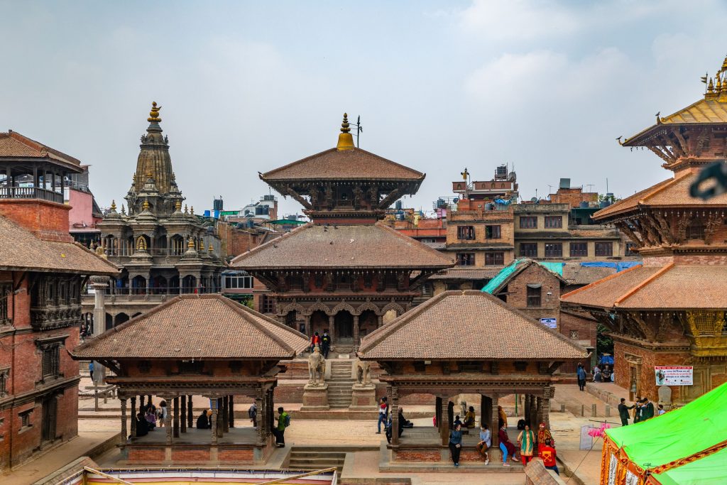 Patan Durbar Square courtyard view with multi-tiered wooden temples and Krishna Mandir in Nepal